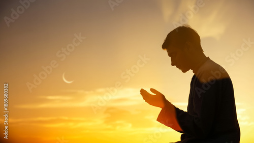 Man Praying Silhouette At Sunset With Crescent Moon For Spirituality And Faith Concept