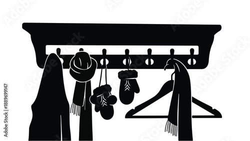 Cozy winter accessories hanging on a wooden coat rack ready for cold weather