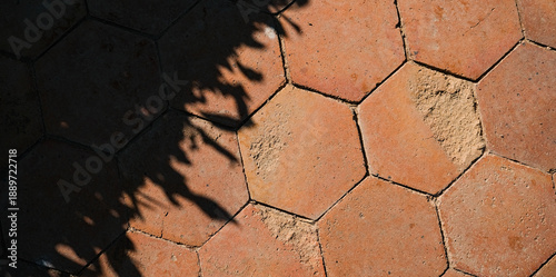 Hexagon outdoor paving stone tiles, paving cobble stone in red terracotta stone color with shadow