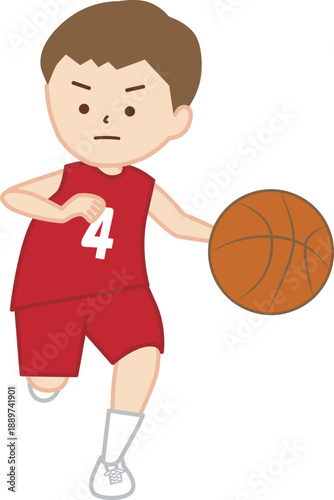バスケットボールの試合でドリブルをする男の子