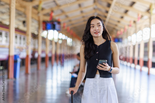 Young asian woman traveling, waiting train at station