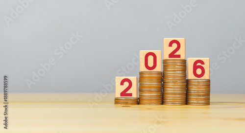 Bild auf Leinwand Rising stacked coins with 2026 on wooden block, copy space