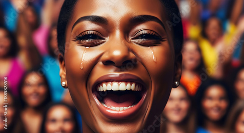 Overwhelmed with pure joy, a radiant woman laughs with tears in her eyes amidst a cheering, supportive crowd, embodying shared happiness and emotional release