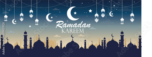 "A beautiful Ramadan Kareem horizontal banner featuring a dark blue and gold gradient sky. The design includes silhouettes of various mosques and minarets at the bottom, with hanging traditional lante