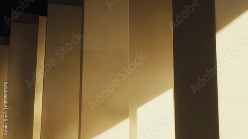 Warm sunlight streaming through a window creating strong geometric shadows and bright reflections on a minimalist corridor's walls and polished floor, emphasizing clean lines and modern design