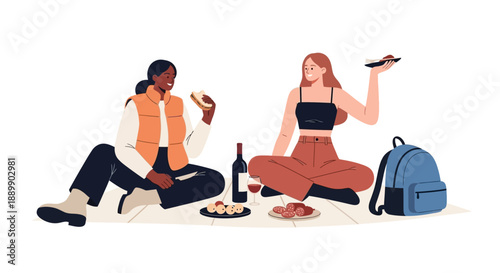 Two women enjoying a leisurely picnic in a serene outdoor setting with food and drinks