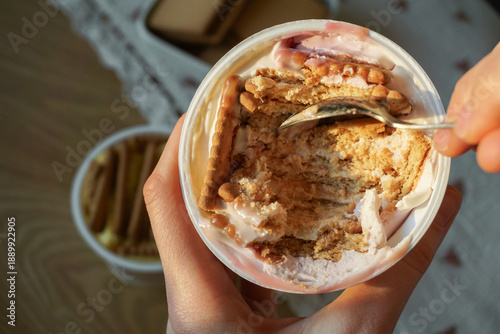 Trendy viral Japanese yogurt cheesecake with cookies biscuit. Preparation of tasty no bake dessert treat at home