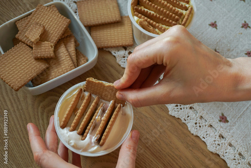 Trendy viral Japanese yogurt cheesecake with cookies biscuit. Preparation of tasty no bake dessert treat at home