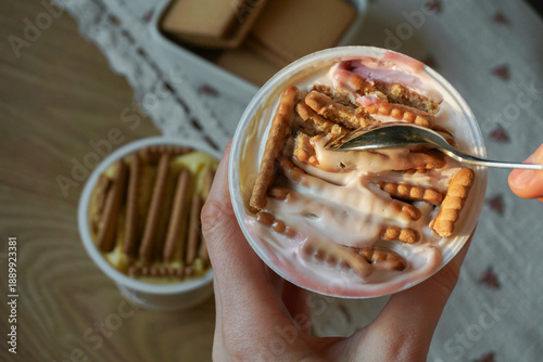 Trendy viral Japanese yogurt cheesecake with cookies biscuit. Preparation of tasty no bake dessert treat at home