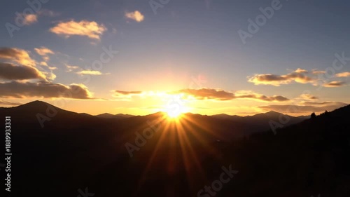 Sunrise over Mountains with Cloudy Sky.