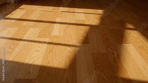 Sunlight Streaming Through Window Onto Wooden Floor.