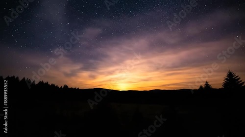 Sunrise Over Silhouetted Landscape with Stars.