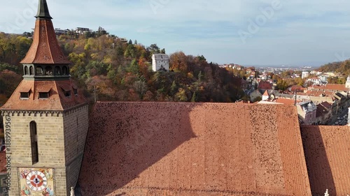 1 november 2024, Brașov, Romania. Forward drone towards and over the black church in the city centre of Brasov toward the white tower.. Beautiful architecture, autumn touristic must-see destination.