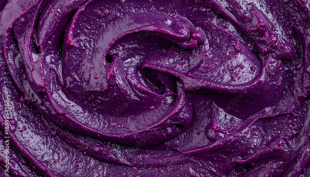 Fototapeta premium Dark purple blueberry jam or puree swirl texture macro top view