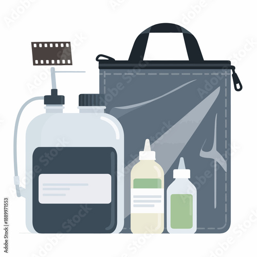 Complete darkroom photography film developing kit including a chemical processing tank, solution bottles, and a lightproof changing bag for analog film enthusiasts.