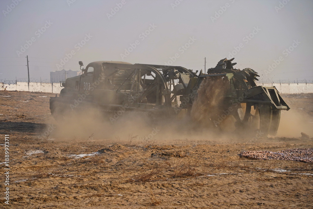 Fototapeta premium Military special equipment digs a trench in a field. Military exercises.