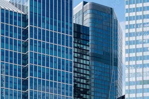 Glass office highrise architecture in frankfurt district with modern corporate skyline shaping business atmosphere under blue sky summer