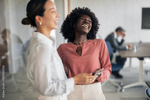 Obraz na płótnie Diverse businesswomen laughing sharing a moment at work