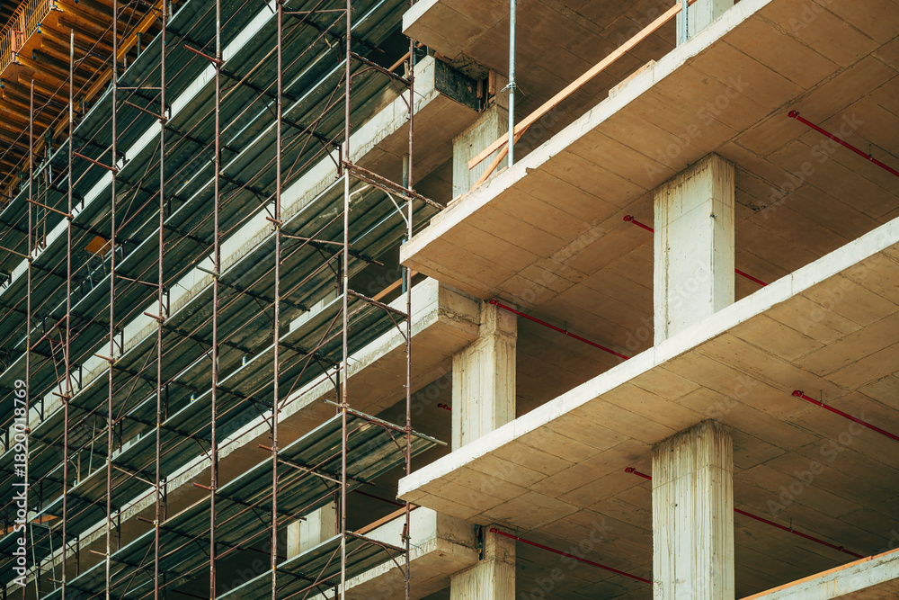Naklejka premium Reinforced concrete form structural building construction site with scaffolding