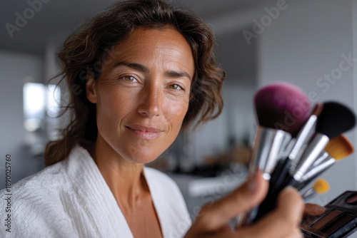 A confident woman showcases an array of makeup tools, representing beauty, creativity, and personal expression with a strong visual impact.