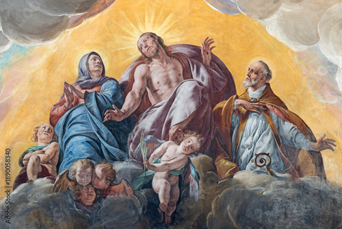 NOVARA, ITALY - JANUARY 16, 2026: The fresco of Jesus with the Virgin mary and St. Gaudentius  in the church Basilica di San Gaudenzio by Antonio d Errico - Tanzio (1629).