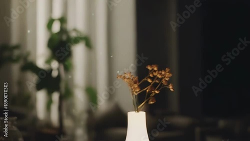 Illuminated vase holding rustic dried flowers, casting a warm soft light, enhancing a tranquil and minimalist living space, ideal for comfort and relaxation concepts