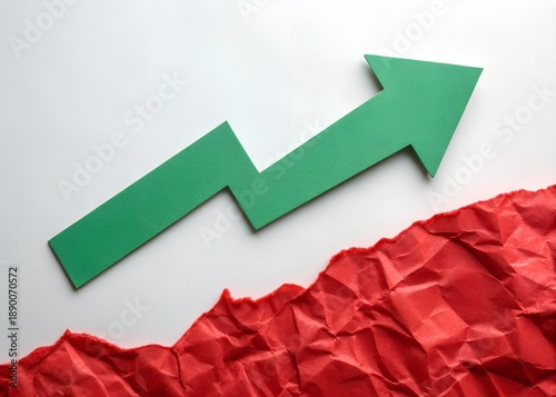 Green arrow pointing up on white background with crumpled red paper