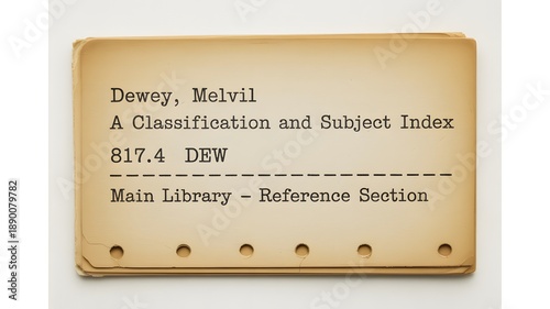 A close-up of a vintage library card catalog with a classification index