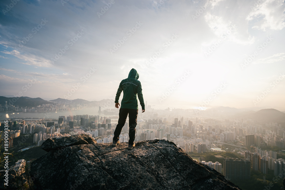Fototapeta premium Tourist enjoy the view stand on the mountain cliff edge in Hong Kong