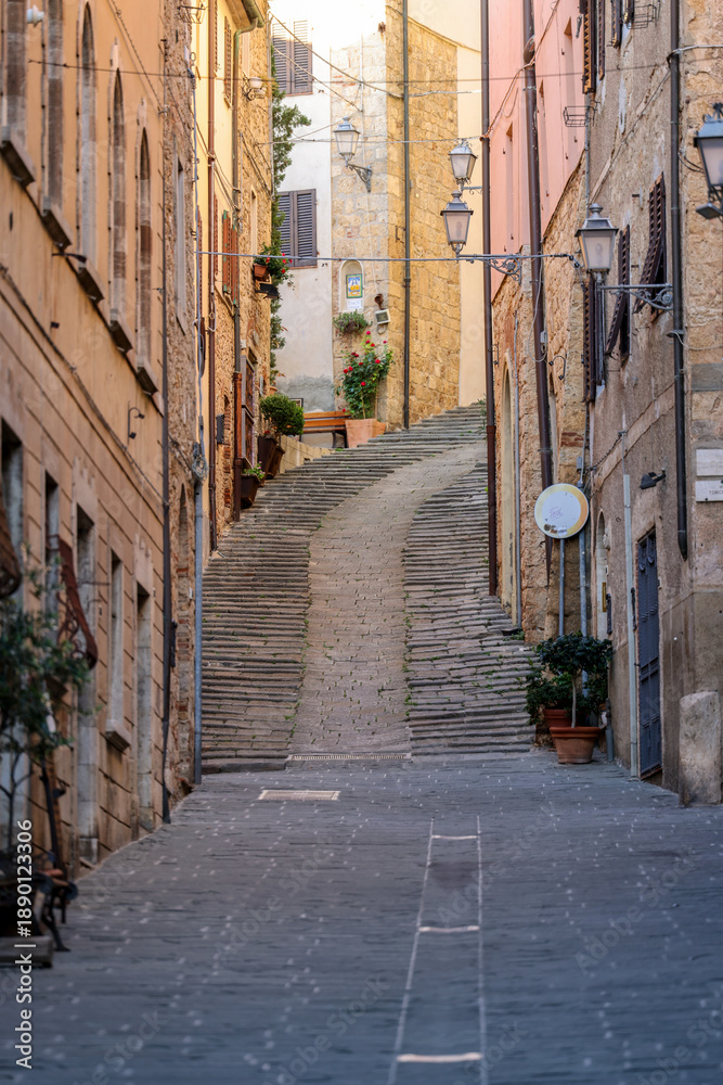 Fototapeta premium Steep and narrow street in old town of Massa Marittima, Italy