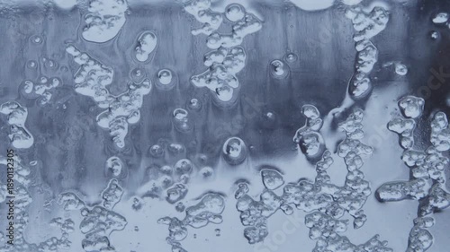 frozen ice and rain dropping down on window glass