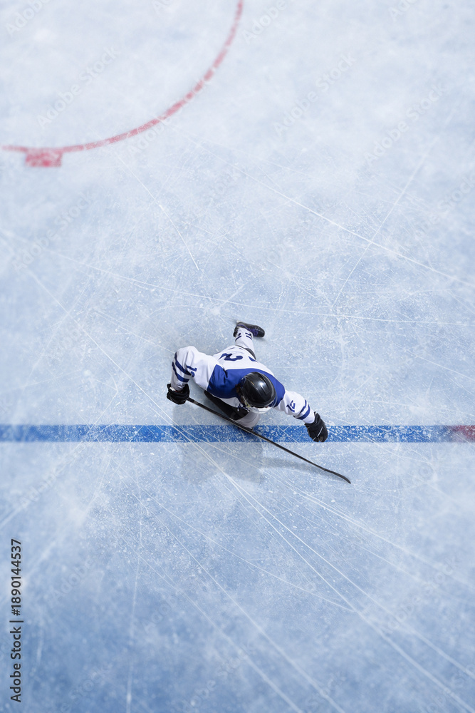 Naklejka premium Clean composition top view ice hockey player crossing blue line during match play. Concept of game tactics, professional league action, sports analytics, competition strategy and broadcast visuals.