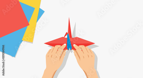 Colorful paper folding activity with hands shaping an origami-inspired craft.