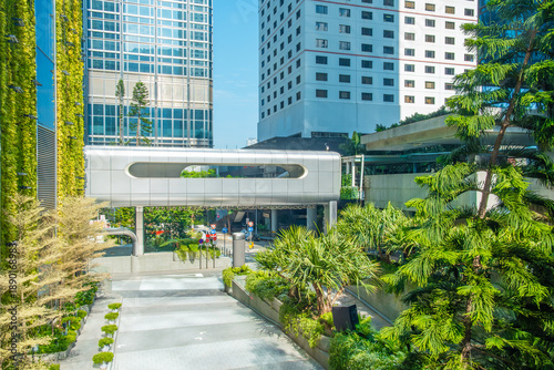 Futuristic elevated walkway with surrounding greenery and modern buildings in Hong Kong city, China. Smart city infrastructure, futuristic urban mobility, innovation, sustainability