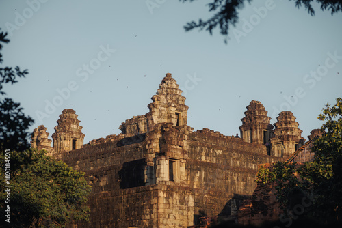 Photos Phnom Bakheng Temple Silhouetted At Sunset Among Trees In Angkor, Cambodia