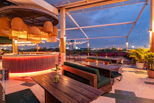 Contemporary roof top bar and cityscape view at twilight.
