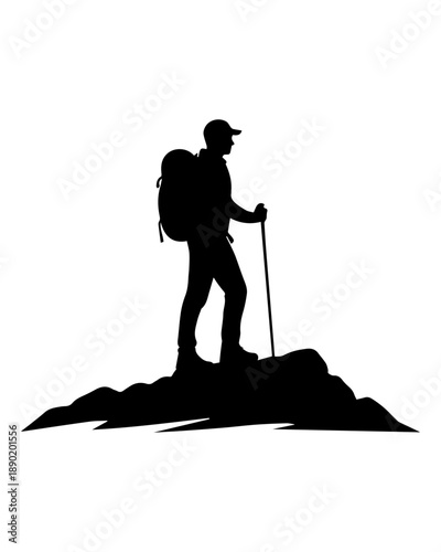Silhouette of a male hiker standing on mountain peak during adventure trek.