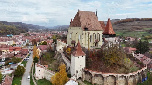 30 october 2024, Biertan, Romania. Forward drone flight in Biertan town, rural village in romania,  with fortified church on hill in Transylvania. Beautiful  touristic must-see destination. mountains,