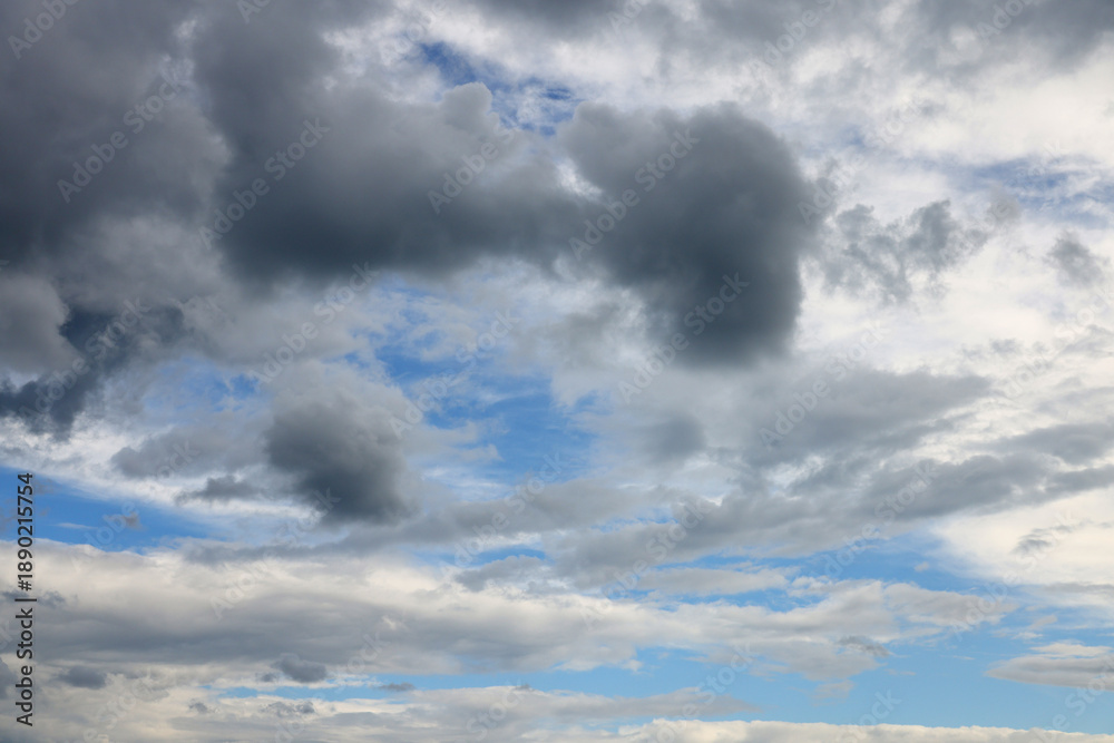 Fototapeta premium Cloudscape filling the sky with varying shades of grey and blue