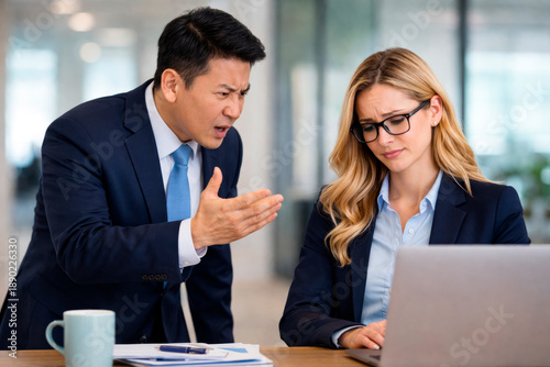 Manager Giving Feedback to Employee During Office Meeting