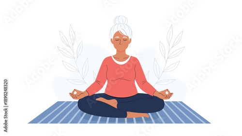 Calm elderly woman with grey hair in a bun practicing meditation and yoga in the lotus position for mindfulness and relaxation.