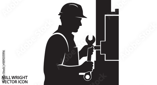 Worker in hard hat holding wrench and working on machinery in industrial setting