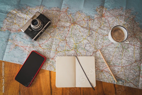Billede på lærred Itinerary planning with map, coffe, smartphone and vintage camera