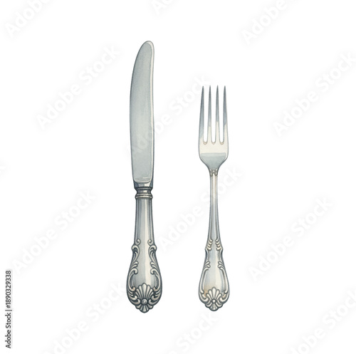 Elegant silver knife and fork with ornate handles standing upright against a clean white background
