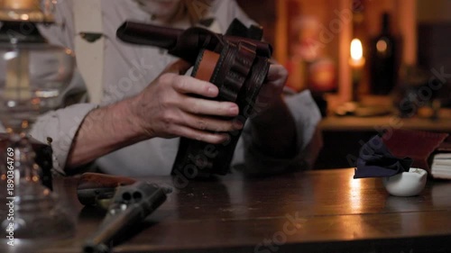 1890 cowboy cleaning his holster closeup
