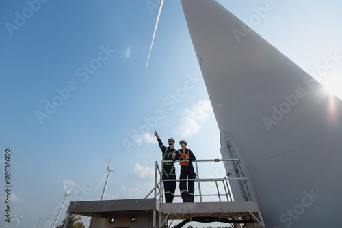 Engineers working on site in wind turbine farm, Wind turbines generate clean energy source, Eco technology for electric, industry environment.