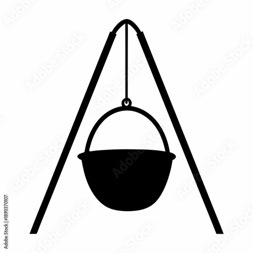 Silhouette of a cauldron hanging over a campfire tripod for cooking outdoors
