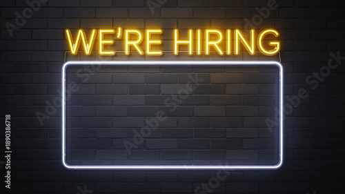 Neon 'We're Hiring' sign on dark brick wall with glowing rectangle