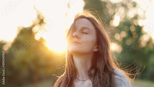 Φωτογραφία Relaxed Woman With Hair Swaying in Wind