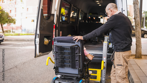 Obraz na plátne Man assisting person in wheelchair accessing mobility transport van with a speci